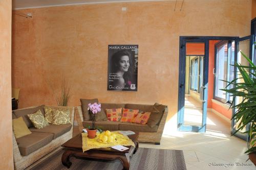 a living room with a couch and a table at Relais La Colombara Spa & Wellness in Travo