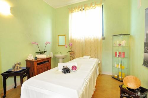 a room with two beds and a sink and a window at Relais La Colombara Spa & Wellness in Travo