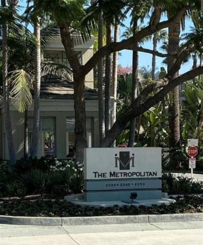 a sign in front of a building with palm trees at CLOUD NINE - Elegance & Comfort in Irvine