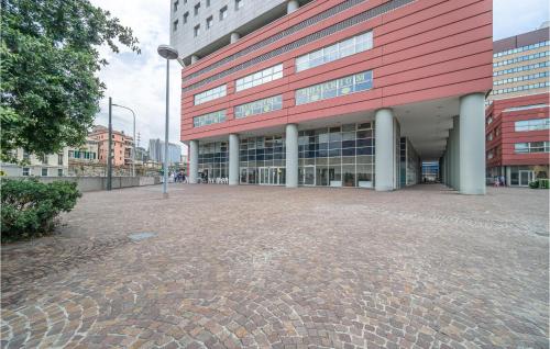 a large building with a brick courtyard in front of it at Awesome Apartment In Genova With Wifi in Genova