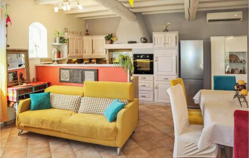 un salon avec un canapé jaune et une cuisine dans l'établissement Amazing Home In Valréas With Wifi, à Valréas