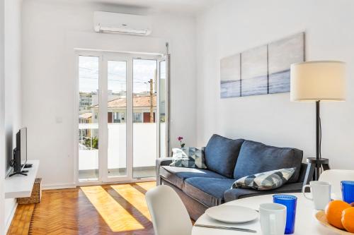 a living room with a couch and a table at RG Sunny Ap in Faro
