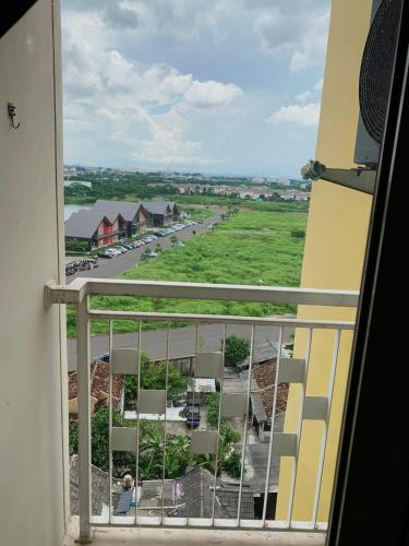 a view of a street from a balcony at The Studio Furnish Springlake Summarecon BCBD with an Amazing View for Healing in Rawabugel