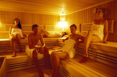 a group of people sitting in a sauna at Hotel Alexander in Weggis