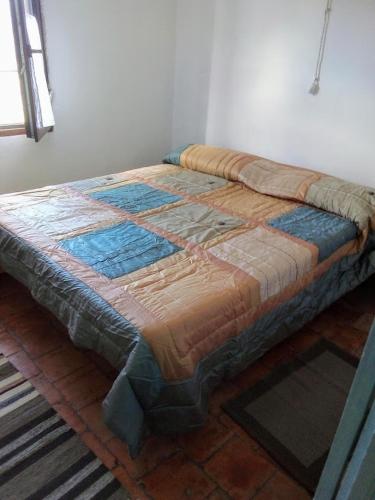 a bed sitting on top of a brick floor at Al Mostarolo in Berceto
