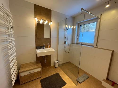 a bathroom with a sink and a shower at Ferienwohnungen Angelika in Garmisch-Partenkirchen