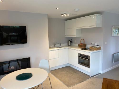 a kitchen with a white table and a table and a table and a table at Room with a View in Holmfirth