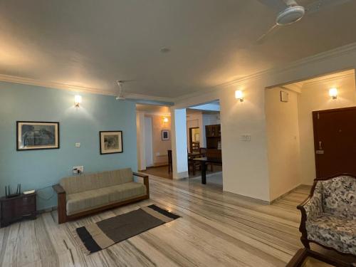 a living room with a couch and a table at Ishan Apartments 3BHK in Vadodara