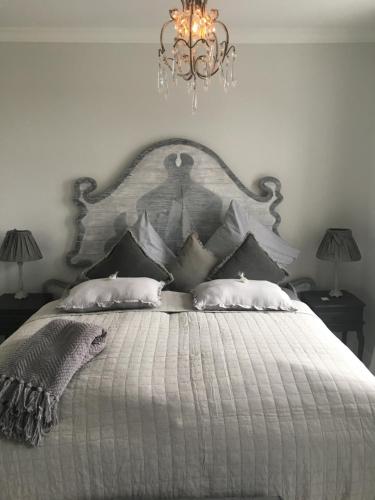 a bedroom with a large bed with a chandelier at SCHLEI LIEBE in Arnis