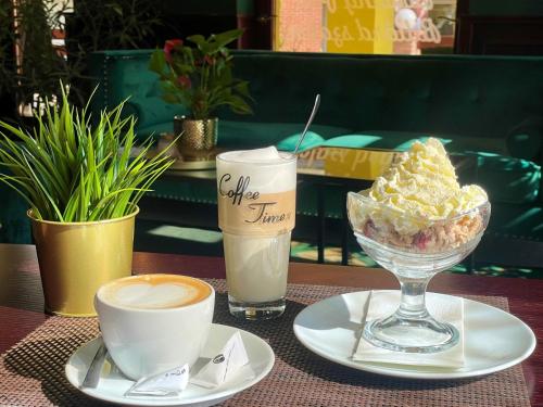 a table with a dessert and two cups of coffee at Chicago Vendégház in Szentes