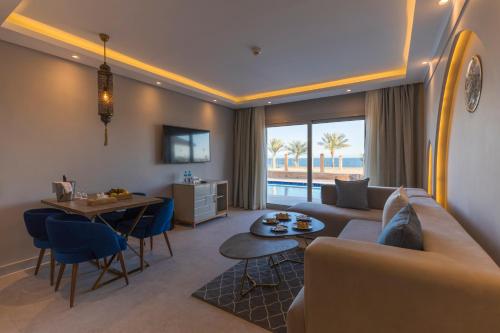 a living room with a couch and a table at Sunrise Diamond Beach Resort -Grand Select in Sharm El Sheikh