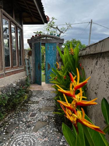 an entrance to a house with a blue door at PINOKKIO B&B Restaurant in Jimbaran