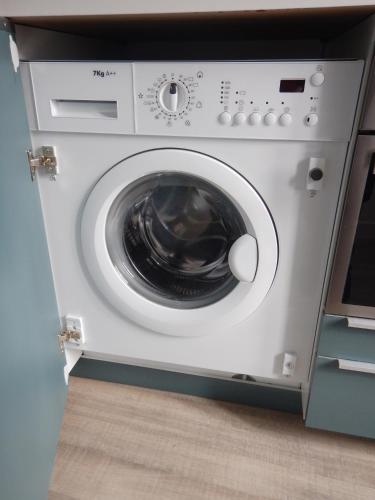 a white washing machine sitting in a kitchen at La Terrazza di Casarico in Moltrasio