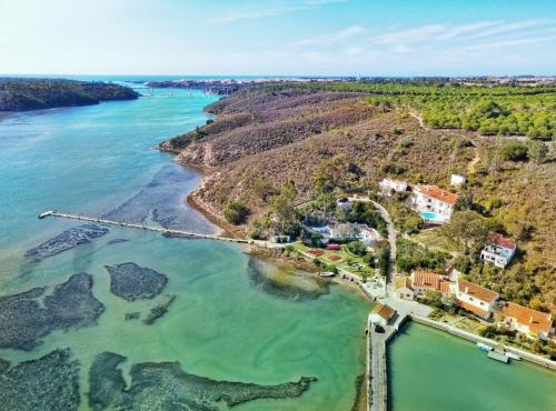 an aerial view of the shoreline of a river at Moinho Da Asneira - Duna Parque Resorts & Hotels in Vila Nova de Milfontes