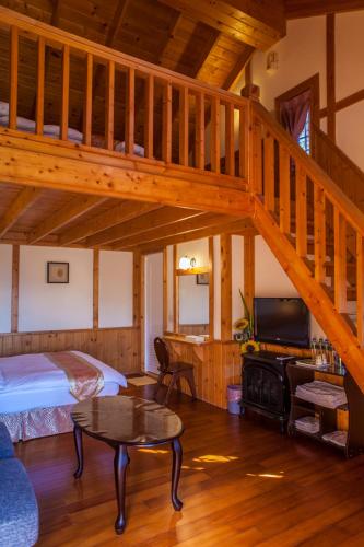 a bedroom with a loft with a bed and a staircase at 清境豐田桂林山莊民宿 in Ren'ai
