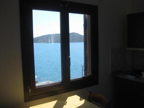 a window with a view of a body of water at Calypso Hotel in Lipsoi