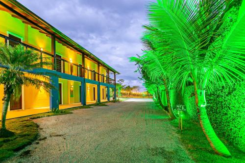 a row of palm trees next to a building at Penareia Floripa Beach Hotel in Florianópolis