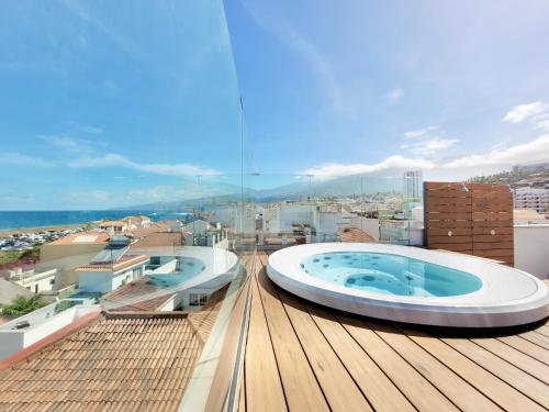 two hot tubs on the roof of a building at Puerto Azul in Puerto de la Cruz