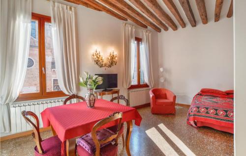 a living room with a red table and a bedroom at Beautiful apartment in Venezia with WiFi in Venice
