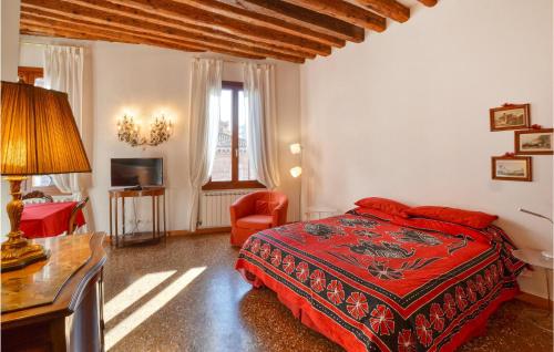 a bedroom with a bed and a desk and a chair at Beautiful apartment in Venezia with WiFi in Venice