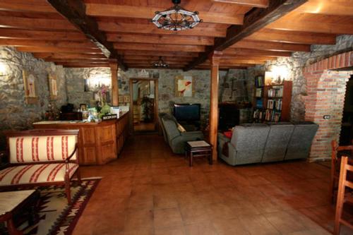 a living room with two couches and a table at Hotel Rural Casa Cueto in Infiesto