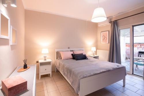 a bedroom with a large bed and a balcony at chora house in Kanálion