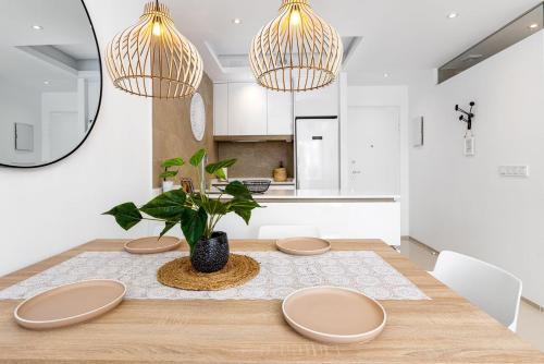 a dining room with a table with a plant on it at Allegra Suites Costa Blanca in Ciudad Quesada