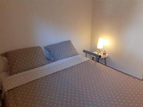 a bedroom with a bed and a table with a lamp at MS Apartments in Izola