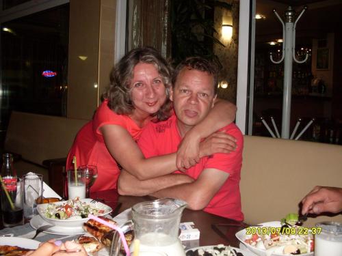 a man and a woman sitting at a table at Dima Popova Apartments in Tsarevo