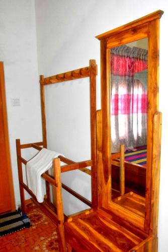 a wooden bunk bed with a window in a room at Wilpattu Lakwin Guest in Pahala Maragahawewa