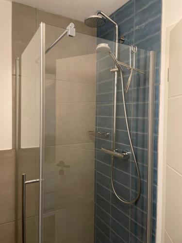 a bathroom with a shower with a glass door at Schicht am Bach in Essen