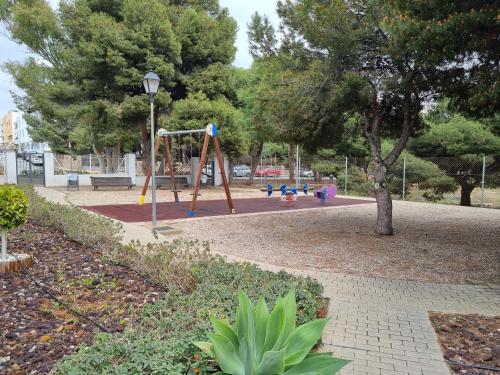 a park with a playground with a swing at Pinar de GARRUCHA in Garrucha