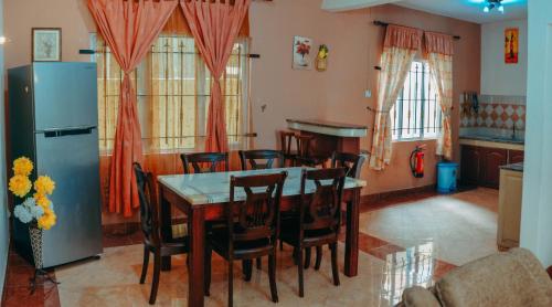 a kitchen with a dining room table and chairs at RS VILLA student share apartments with private room,free wifi ,100mts to the beach in Flic-en-Flac