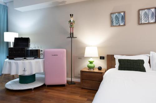 a bedroom with a white bed and a pink heater at Lo Schiaccianoci Bed&Breakfast de Charme in Scanzorosciate