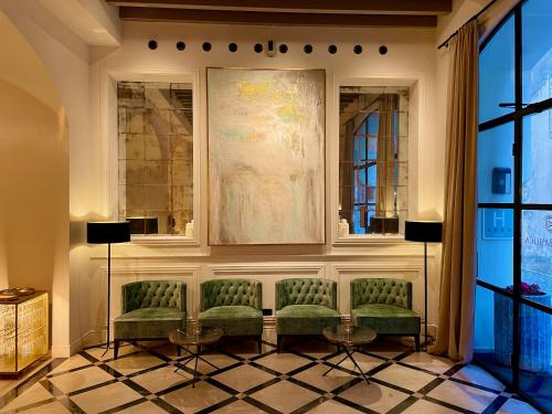 a waiting room with chairs and a painting on the wall at Hotel Basilica in Palma de Mallorca