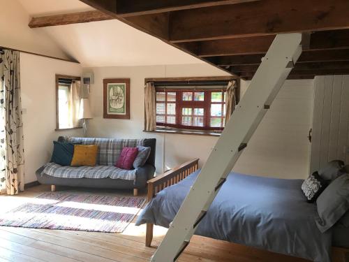 a living room with a bed and a couch at sika lodge in Wareham