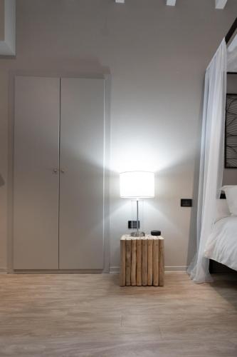 a bedroom with a bed and a table with a lamp at Lo Schiaccianoci Bed&Breakfast de Charme in Scanzorosciate