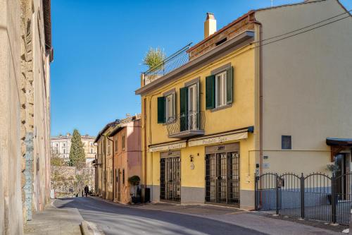 a yellow building on the side of a street at Casa Checca e Casa Maria appartamenti per vacanze in Caprarola