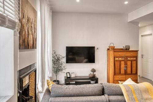 a living room with a couch and a fireplace at Casa Checca e Casa Maria appartamenti per vacanze in Caprarola