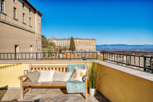 a balcony with a bench and a chair on a building at Casa Checca e Casa Maria appartamenti per vacanze in Caprarola