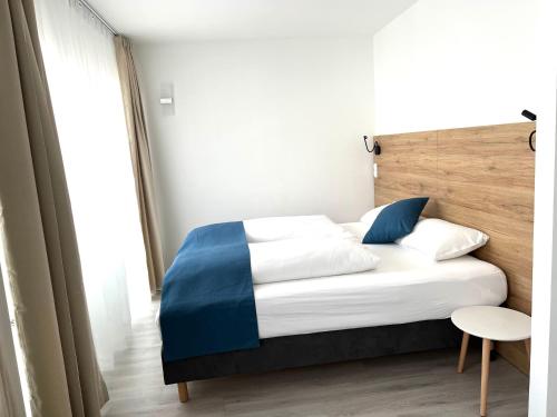 a bed in a room with a white bedspread at Hotel 83 in Bonn