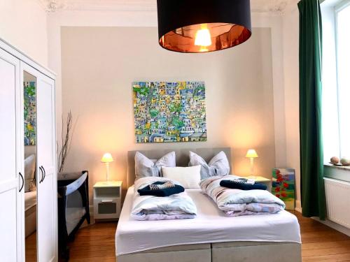 a bedroom with a white bed with pillows on it at VILLA HanseART Lübeck - Privatzimmer in zentraler Lage in Lübeck
