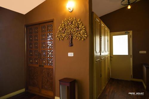 a hallway with a door and a clock on the wall at Pear Mount Farm House in Kodaikānāl