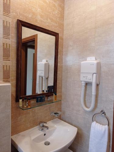 a bathroom with a sink and a mirror at Lilia Sun Apartment in Sozopol