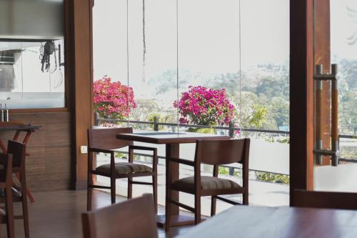 a dining room with a table and chairs and a window at Heaven Seven Kandy in Kandy