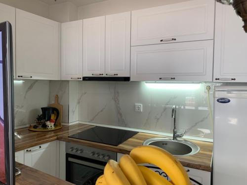 a kitchen with white cabinets and a sink at Villa Stefanija in Ohrid