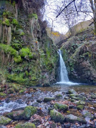 a waterfall in the middle of a river at Hotel Rural Casa Cueto in Infiesto
