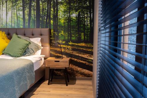 a bedroom with a bed and a table with a window at Gite Au Coeur de Han in Han-sur-Lesse