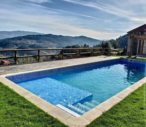 a swimming pool with a view of the mountains at CASAS DA MORGADINHA - Casas de Férias e Turismo Rural in Celorico de Basto