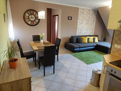 a living room with a couch and a table at SaMuci Apartman in Hajdúszoboszló